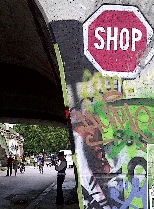 Shop graffiti and trumpet playing guy on the Waltz, Donaukanal, Vienna, Austria